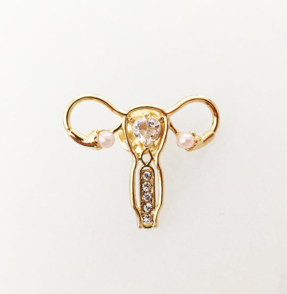 Broche en forme d'utérus doré